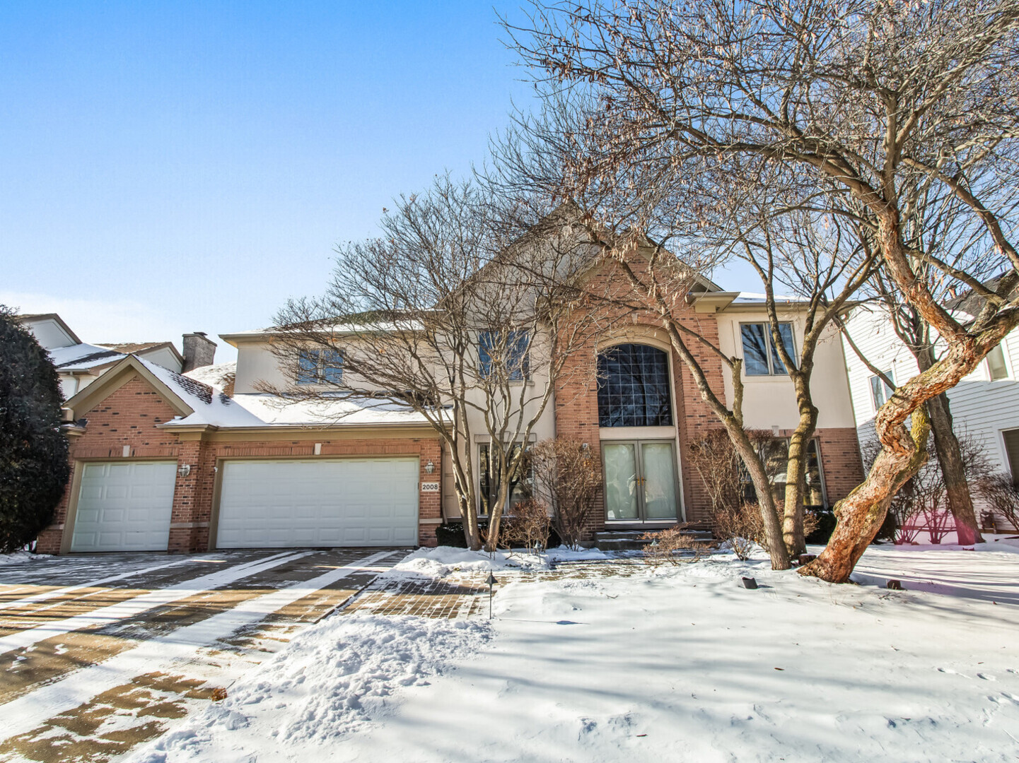 a view of a house with snow on the road