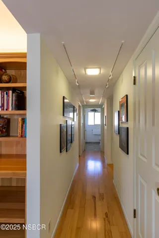 a view of a hallway with wooden floor