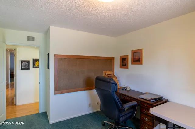 a bathroom with a toilet a sink a mirror and a window