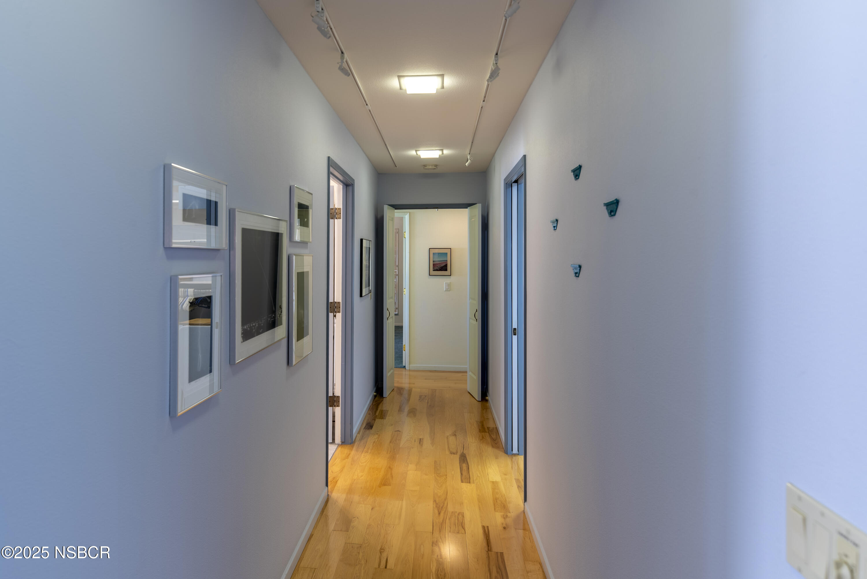 4490 Sirius Avenue Lompoc, CA 93436 - Photo 35 of 55 a view of a hallway with wooden floor and a bathroom