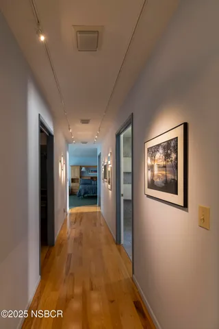 a utility room with dryer washer and a view of living area
