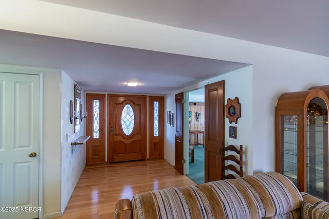 a bedroom with a bed a mirror and a window