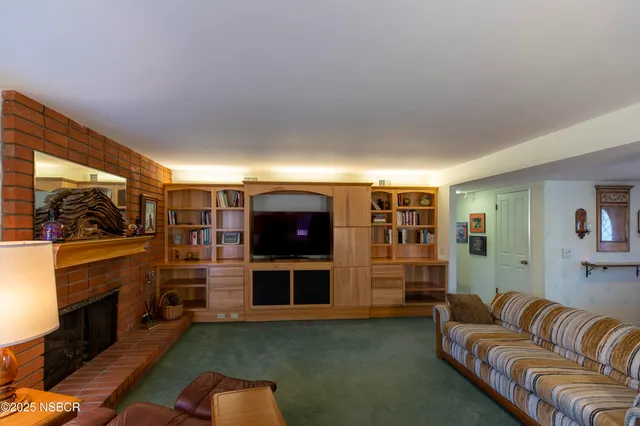 a living room with fireplace furniture and a flat screen tv
