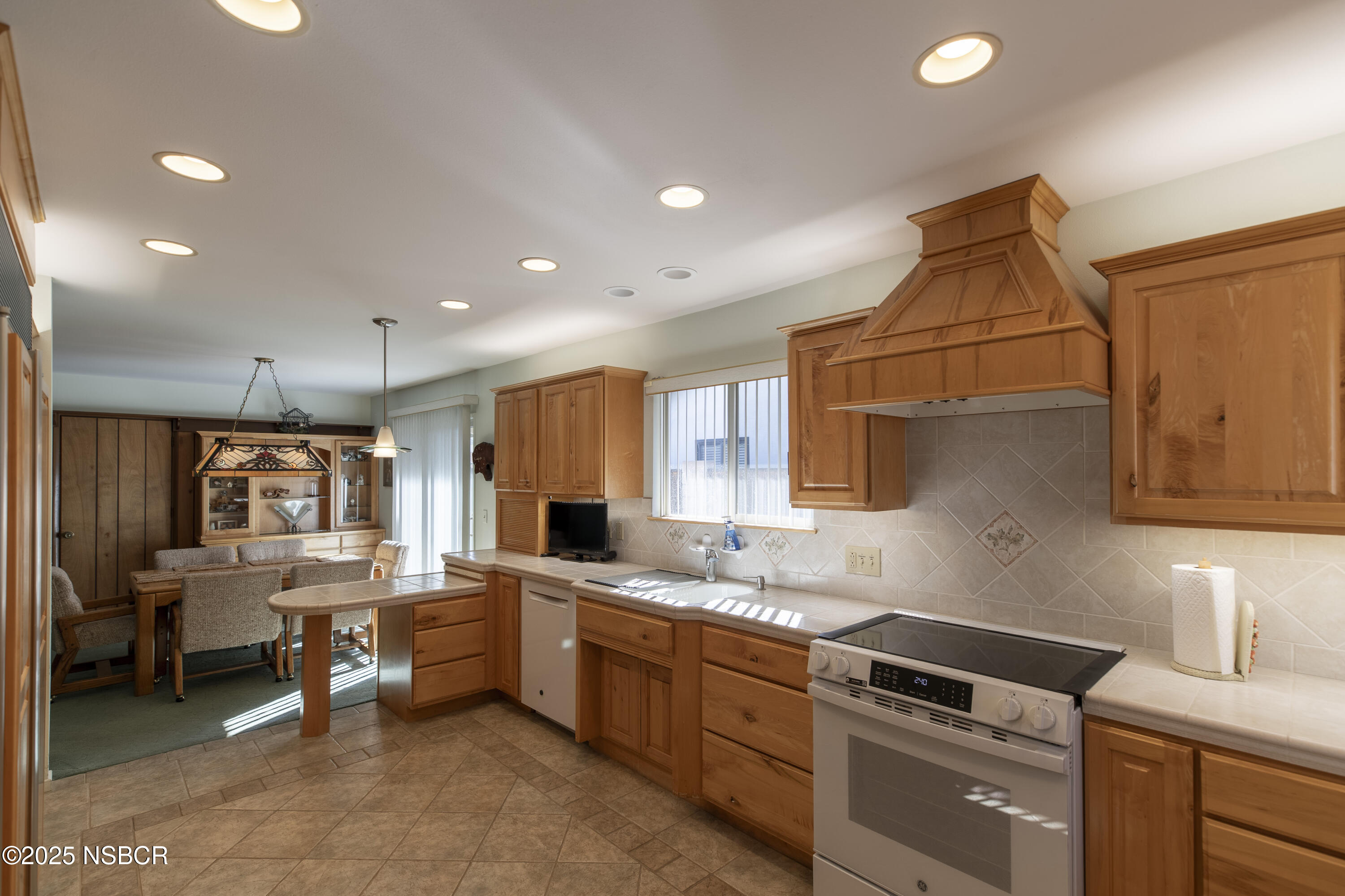 4490 Sirius Avenue Lompoc, CA 93436 - Photo 10 of 55 a kitchen with white cabinets and appliances