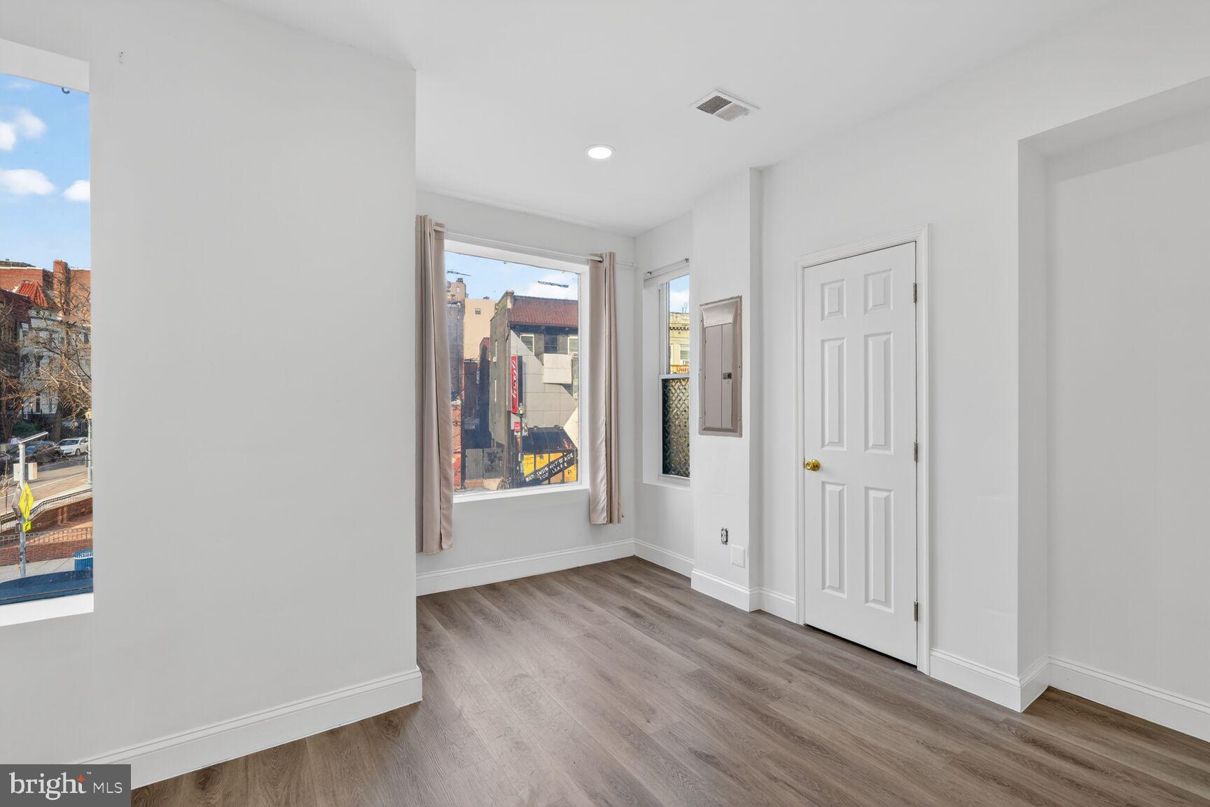 2409 18th Street Northwest, Unit 2 Washington, DC 20009 - Photo 13 of 19 an empty room with wooden floor and windows