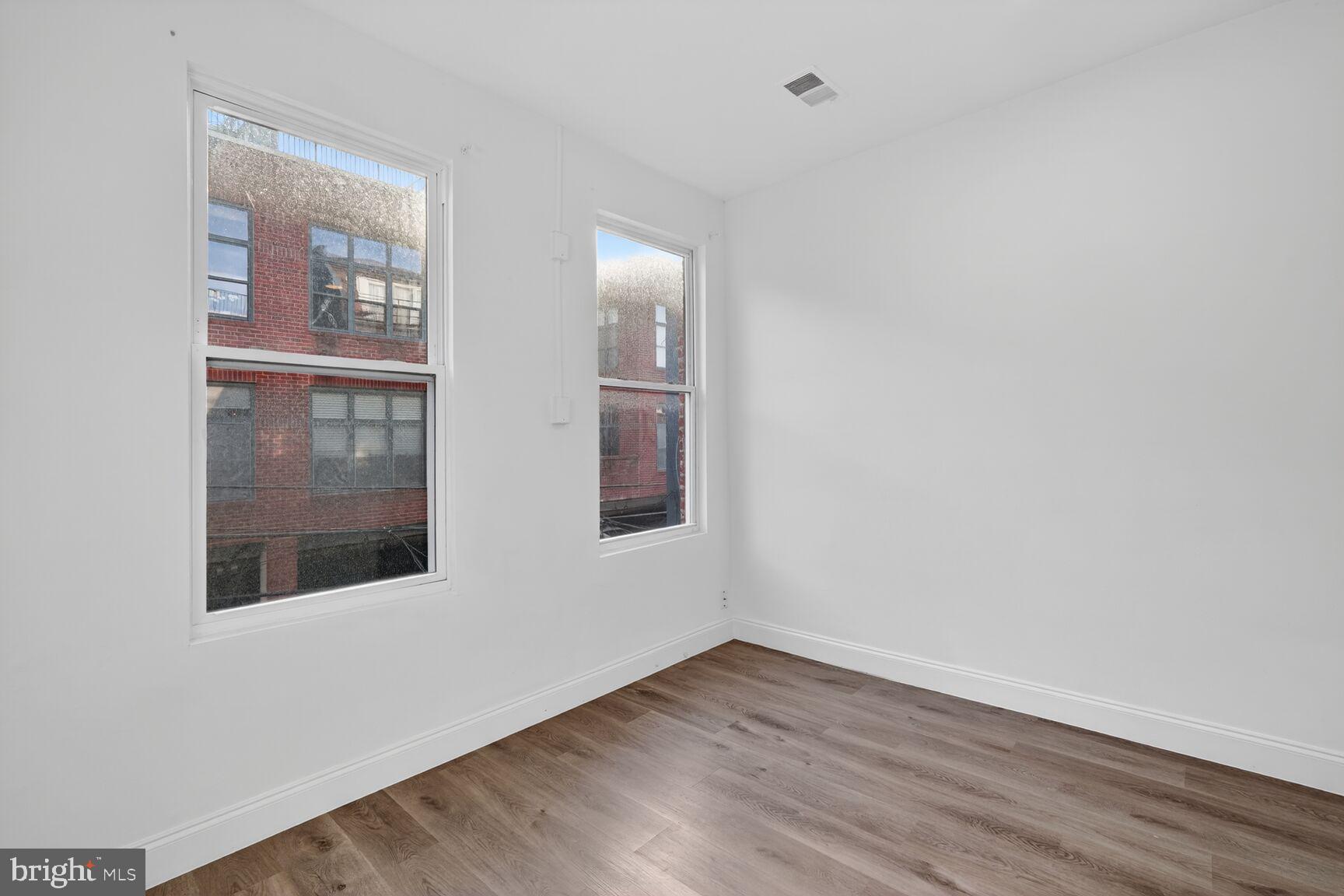 2409 18th Street Northwest, Unit 2 Washington, DC 20009 - Photo 16 of 19 a view of an empty room with wooden floor and windows