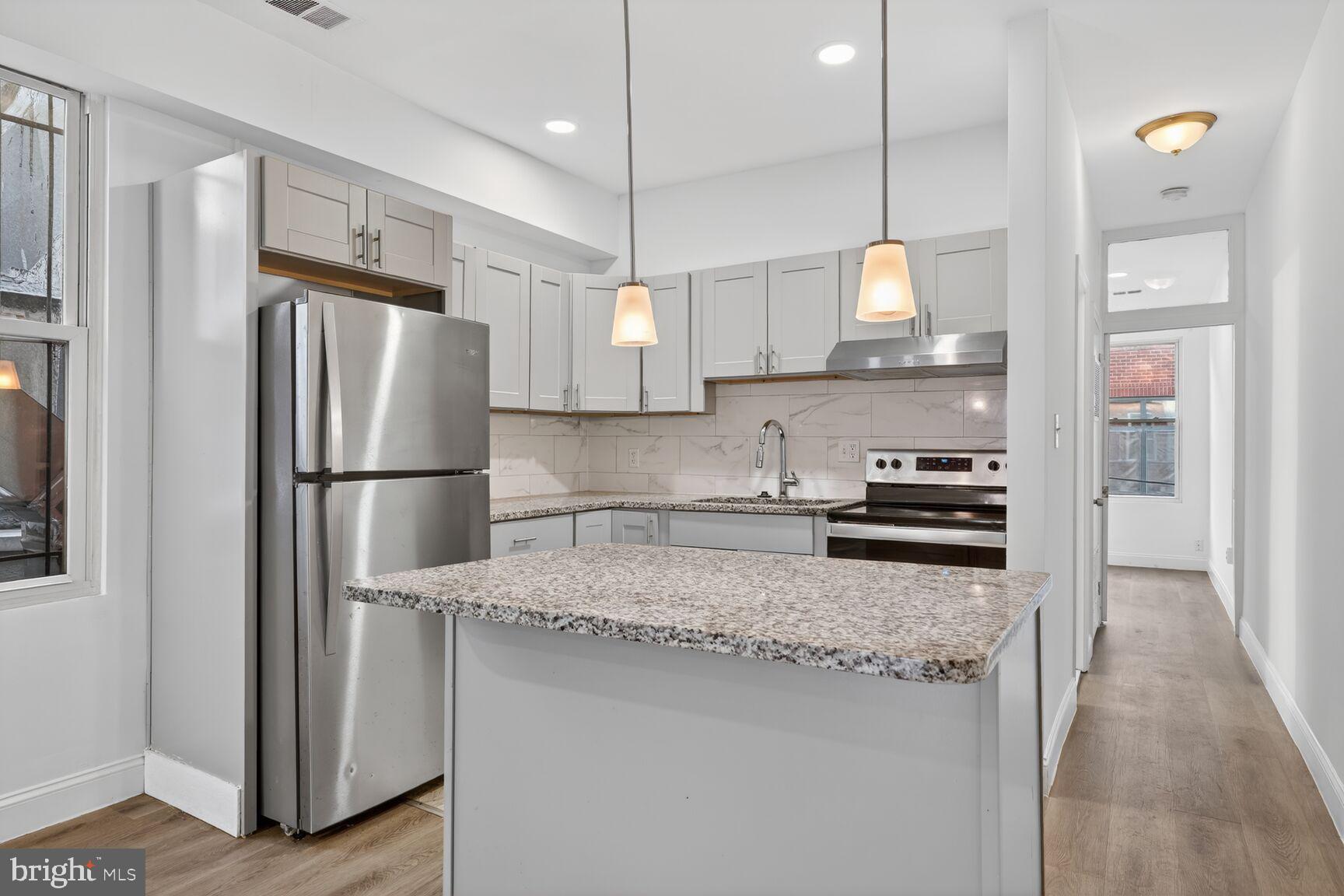 2409 18th Street Northwest, Unit 2 Washington, DC 20009 - Photo 6 of 19 a kitchen with stainless steel appliances granite countertop a refrigerator a sink and a stove