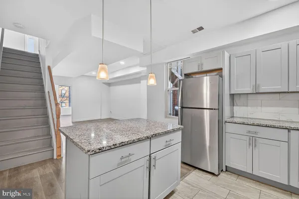 a kitchen with a refrigerator a microwave and cabinets