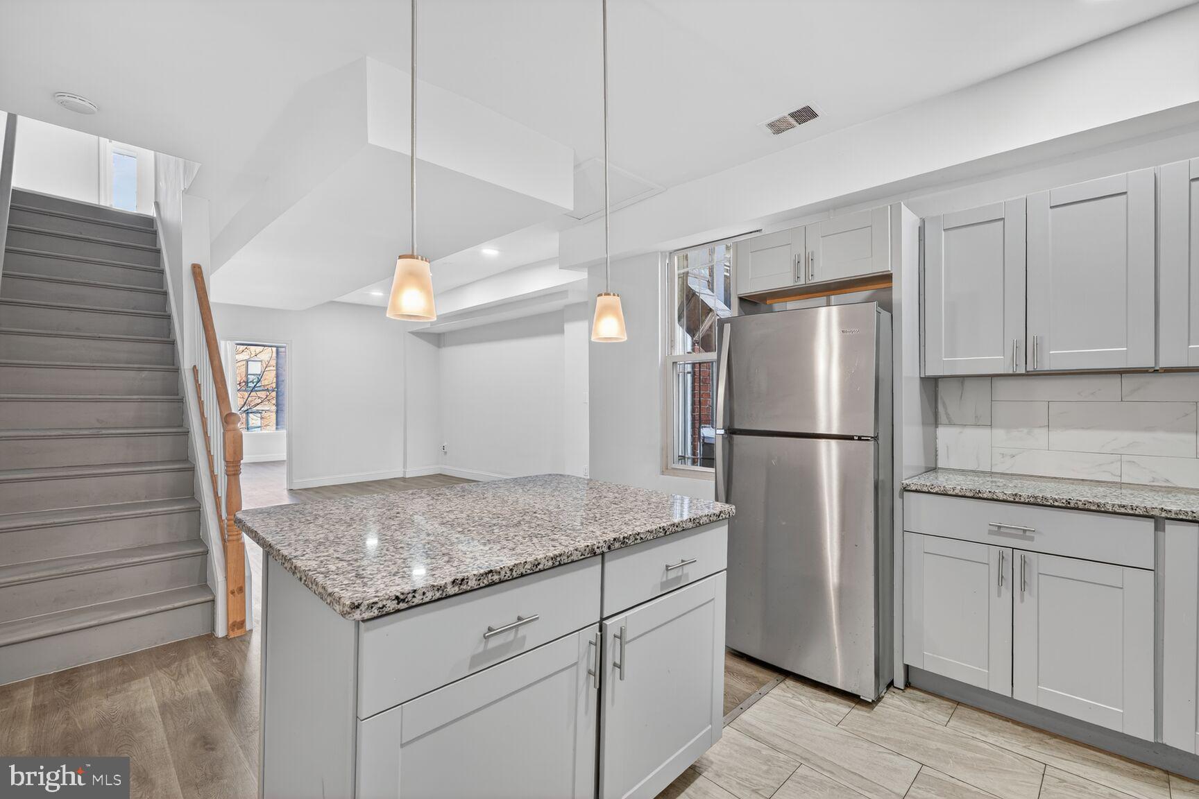 2409 18th Street Northwest, Unit 2 Washington, DC 20009 - Photo 8 of 19 a kitchen with a refrigerator a microwave and cabinets