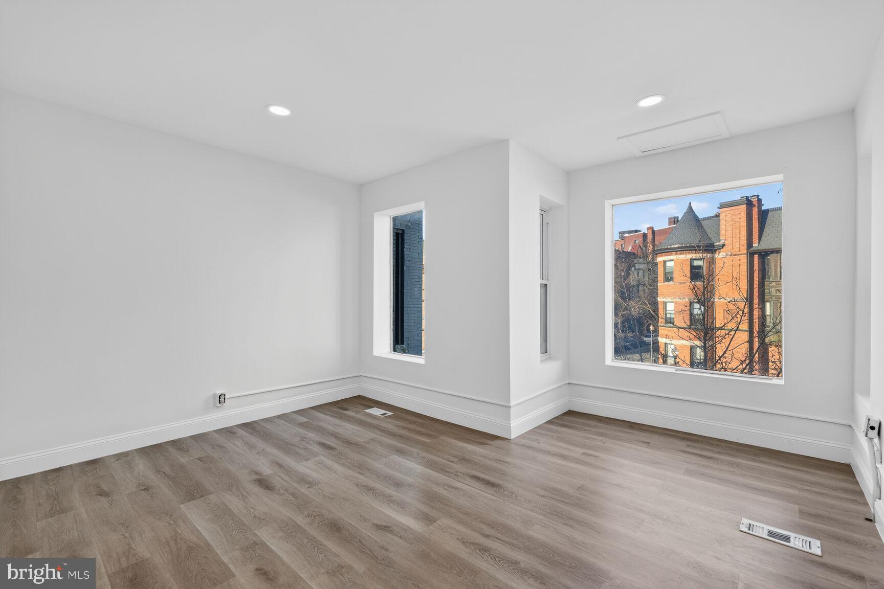 2409 18th Street Northwest, Unit 2 Washington, DC 20009 - Photo 10 of 19 an empty room with wooden floor and windows