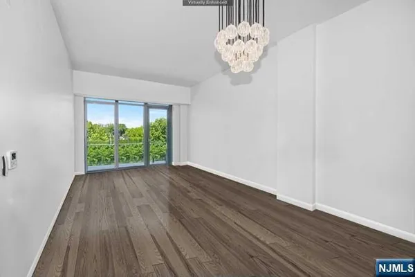 a view of a hallway with wooden floor and a large window