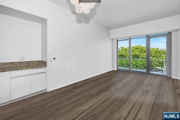 a view of wooden floor and window in a room
