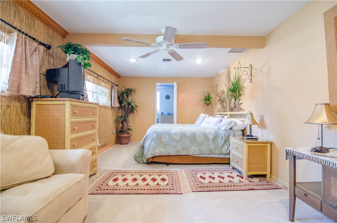 2124 Pineview Road Fort Myers, FL 33901 - Photo 16 of 25 a bedroom with furniture and a chandelier