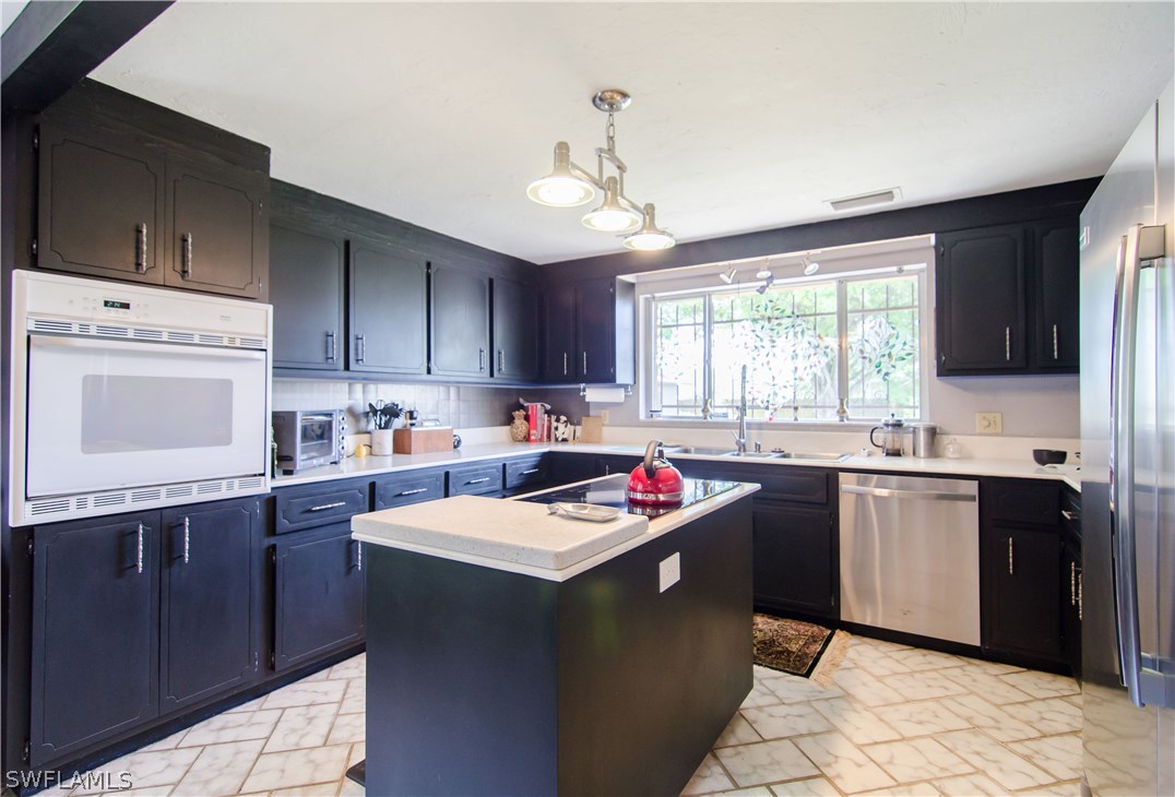 2124 Pineview Road Fort Myers, FL 33901 - Photo 8 of 25 a kitchen with a sink window and cabinets