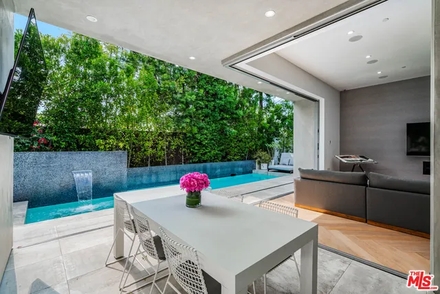a view of a dining table and chairs in the patio