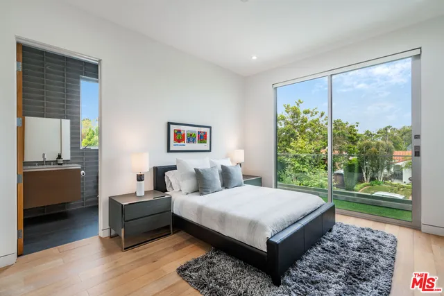 a bedroom with a bed a couch and a window