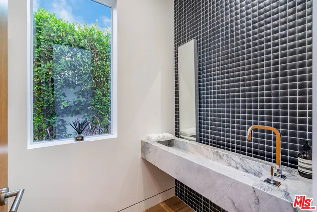 a bathroom with a sink toilet and window