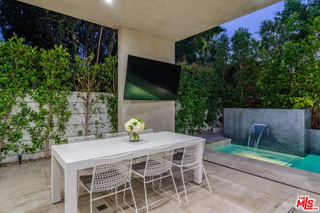 a view of an outdoor dining space with a table and chairs