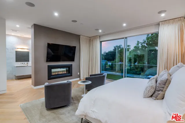 a bed room with a bed and a television