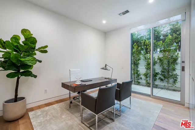 a dining room with furniture and wooden floor