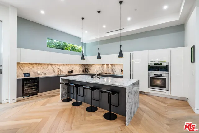 a kitchen with stainless steel appliances granite countertop a stove and a refrigerator