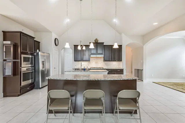 a large kitchen with a table and chairs