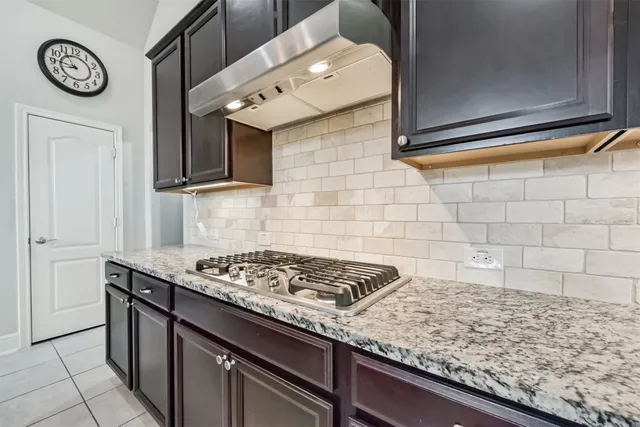 a kitchen with stainless steel appliances granite countertop a sink and cabinets