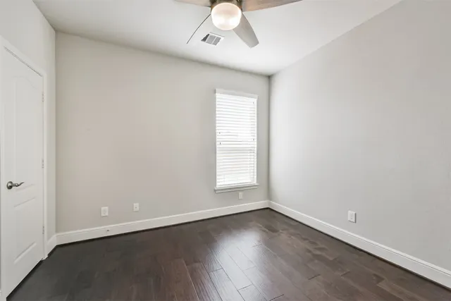 a bathroom with a granite countertop sink a toilet and a mirror