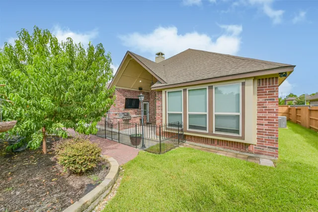 a view of a house with a yard and sitting area