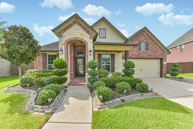 a front view of a house with a yard and garage