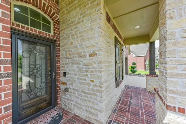 a view of a brick house with a large window