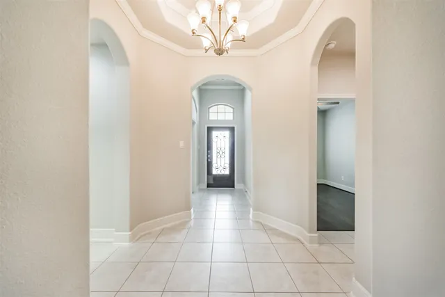 a view of a hallway with wooden floor and a bathroom