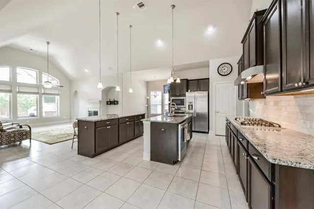 a large kitchen with a large counter top appliances and cabinets