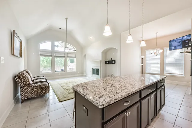 a bathroom with a granite countertop sink and a large mirror