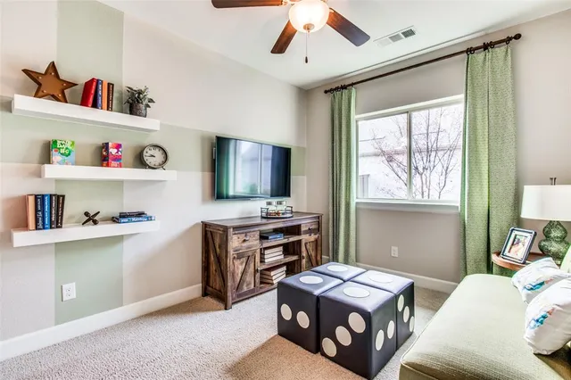 a bedroom with bed and a painting on the wall
