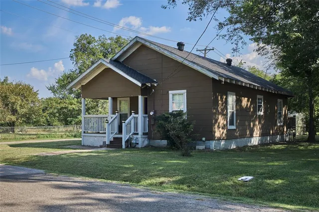 a front view of house with a garden