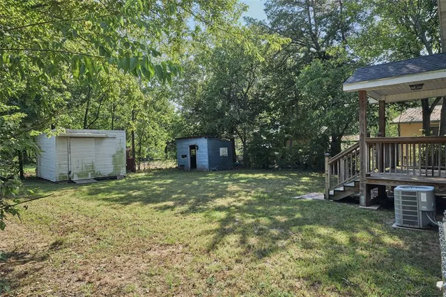 a view of a house with a patio and a yard
