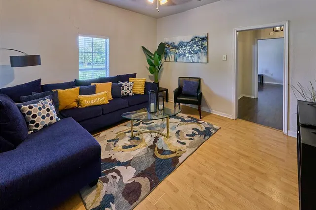 a living room with furniture and a wooden floor
