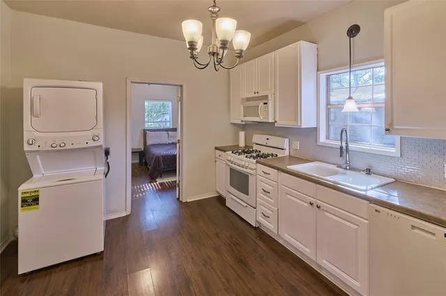 a view of a bedroom with wooden floor and a bed