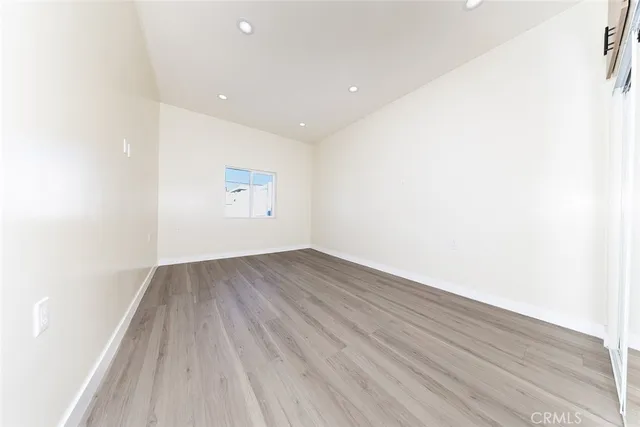 a view of a room with wooden floor and white walls
