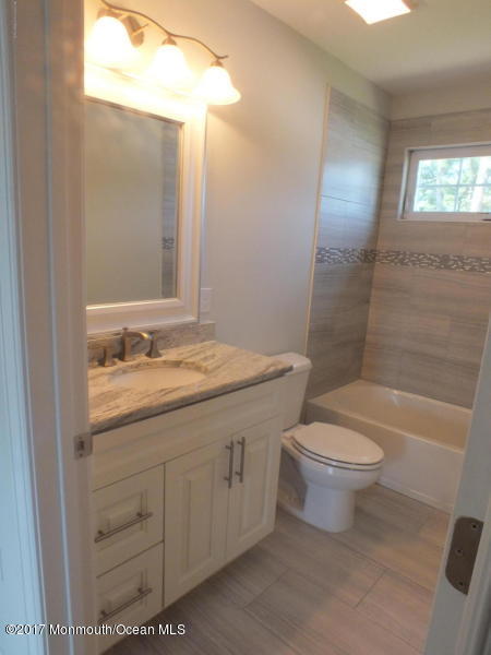 301 Leeward Road Manahawkin, NJ 08050 - Photo 8 of 11 a bathroom with a granite countertop toilet a sink and a bathtub