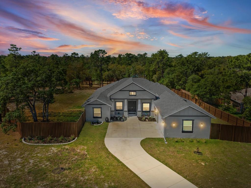 11981 Robina Road Weeki Wachee, FL 34614 - Photo 1 of 93 a front view of a house with a yard