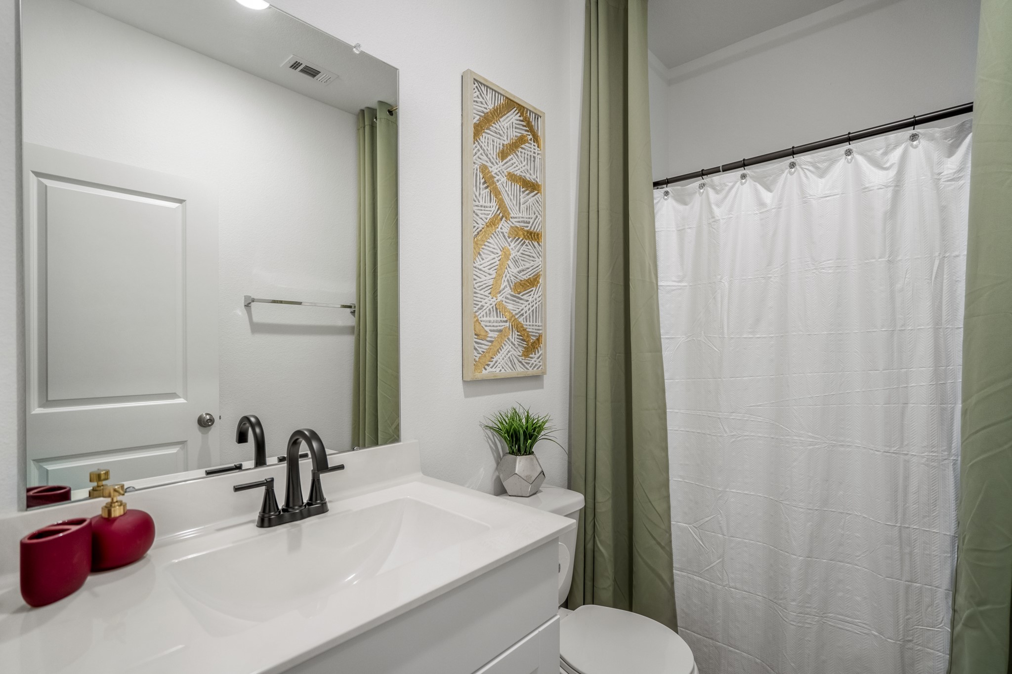 10477 Pineland Drive Willis, TX 77378 - Photo 11 of 27 a bathroom with a sink toilet and a mirror