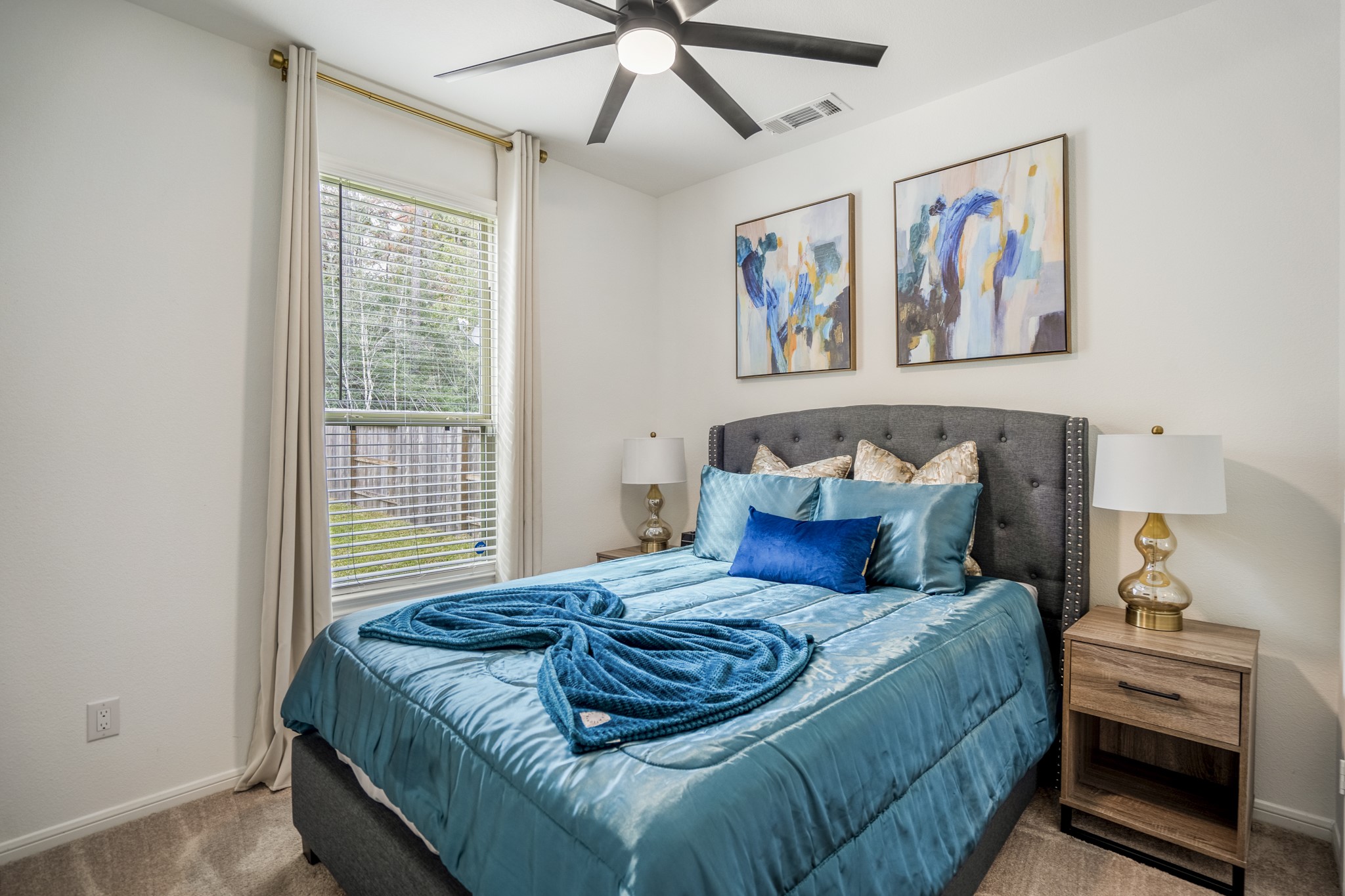 10477 Pineland Drive Willis, TX 77378 - Photo 12 of 27 a bedroom with a bed and a painting on the wall