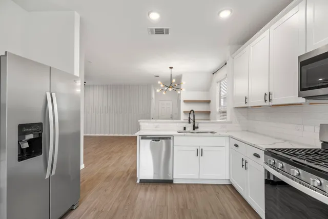 a bathroom with a sink a toilet and a window