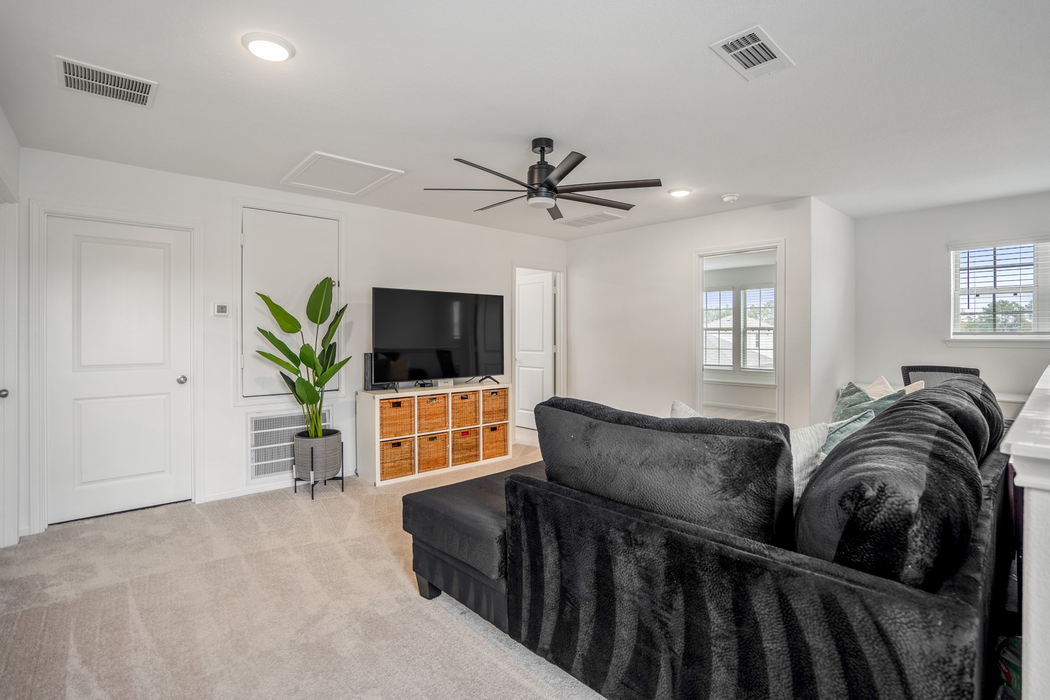 10477 Pineland Drive Willis, TX 77378 - Photo 15 of 27 a living room with furniture a flat screen tv and a window