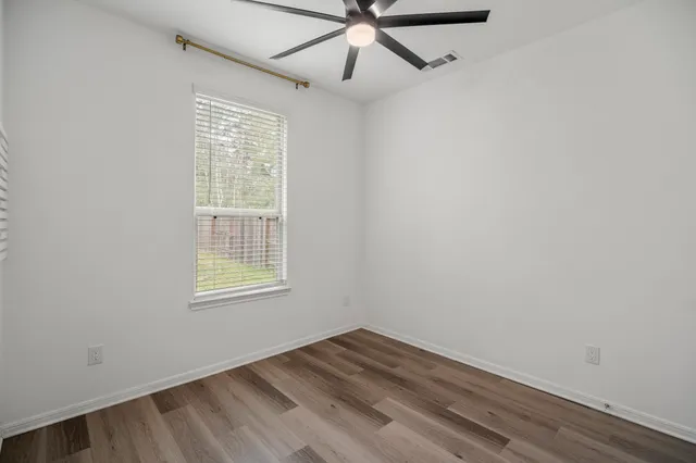 a en suite spacious bathroom with a granite countertop double vanity sink a mirror and a shower