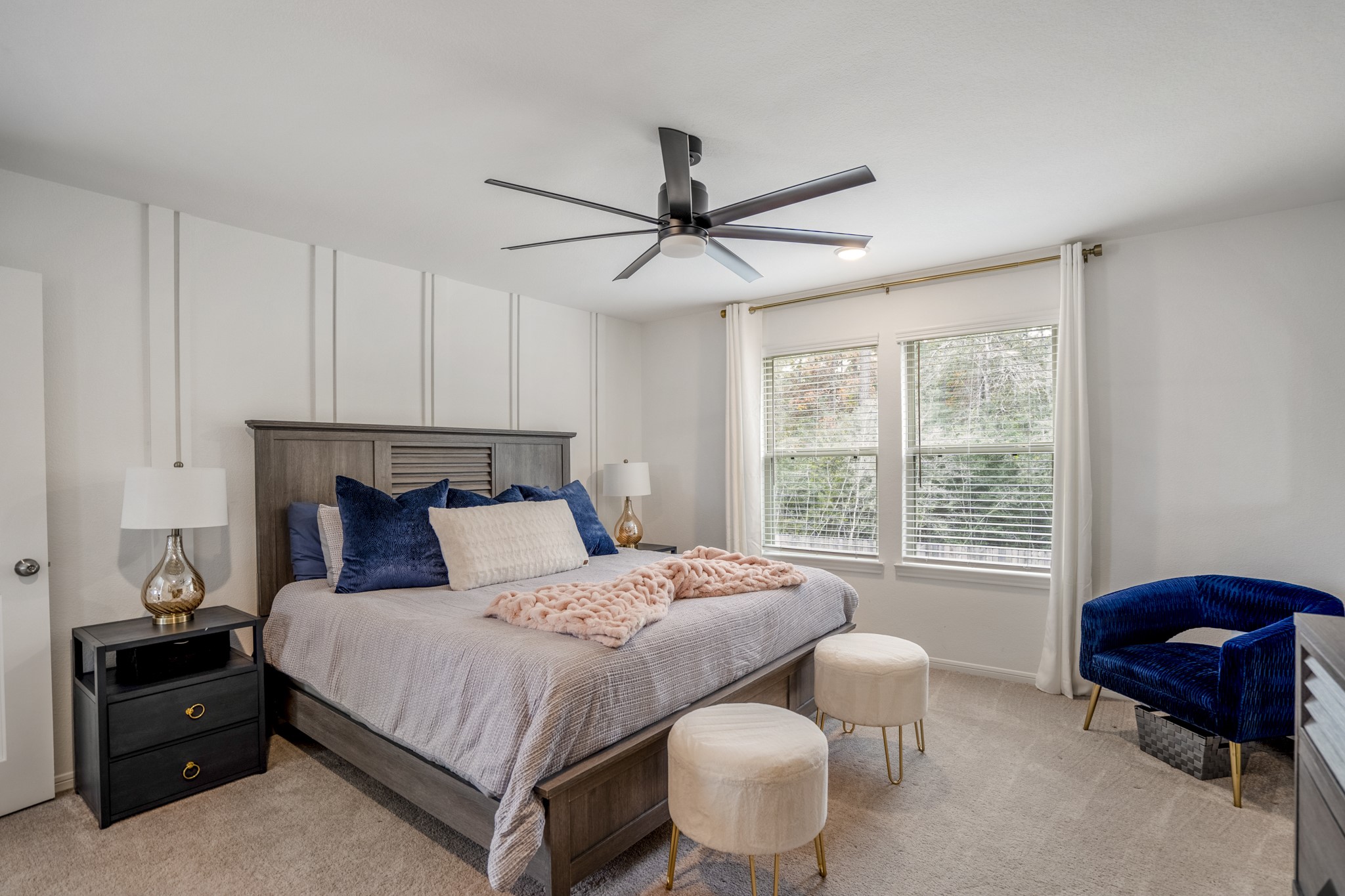 10477 Pineland Drive Willis, TX 77378 - Photo 19 of 27 a bedroom with a bed and a chandelier