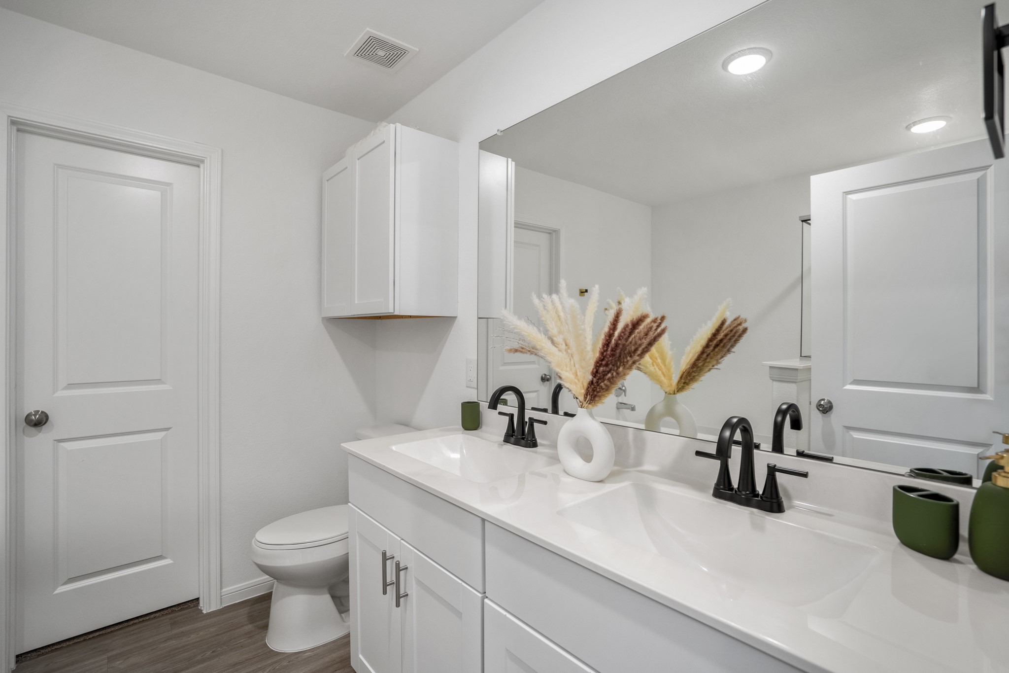 10477 Pineland Drive Willis, TX 77378 - Photo 20 of 27 a bathroom with a sink a toilet and vanity