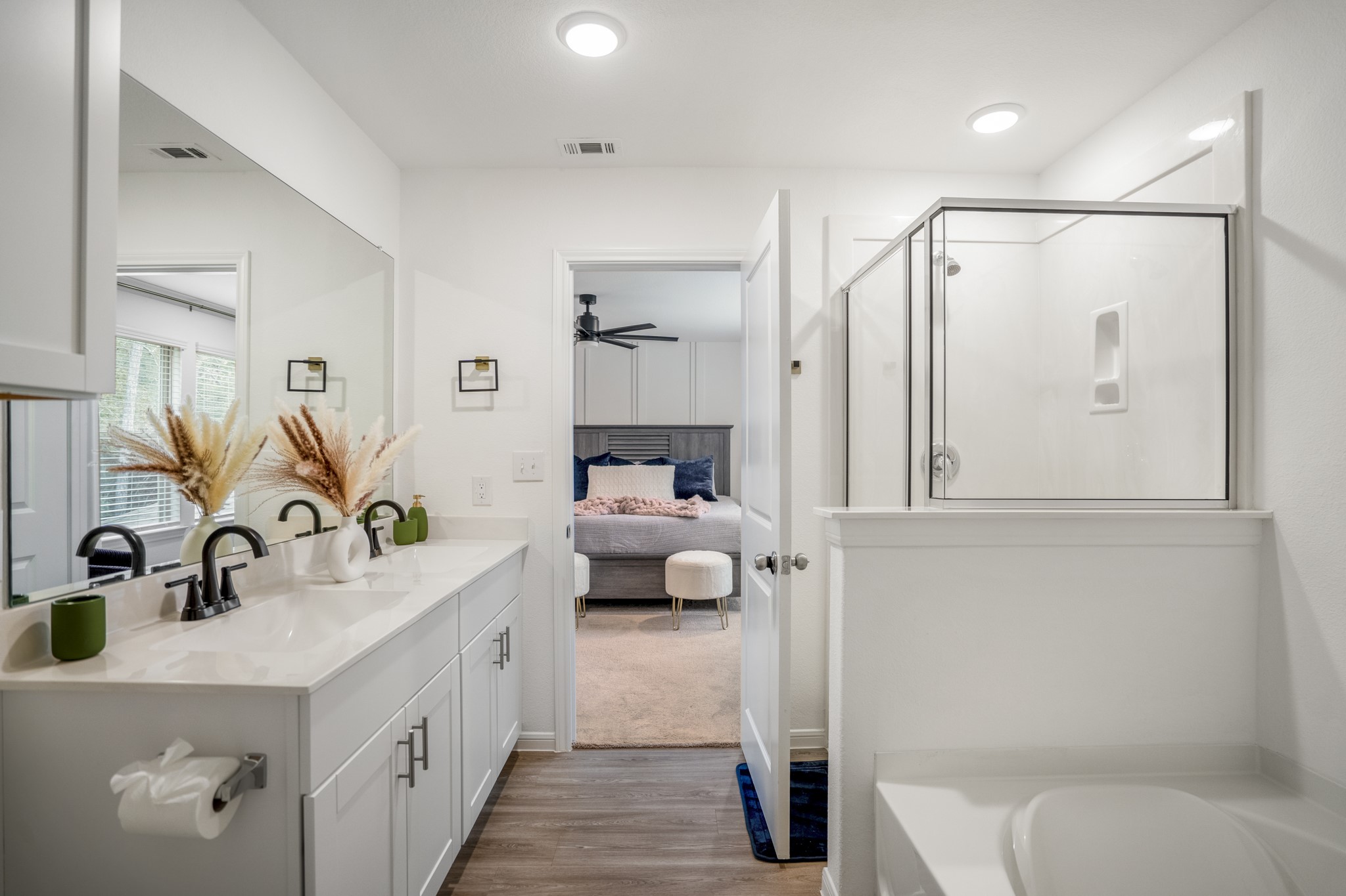 10477 Pineland Drive Willis, TX 77378 - Photo 21 of 27 a en suite spacious bathroom with a granite countertop double vanity sink a mirror and a shower